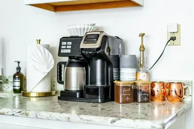 a coffee maker sitting on top of a counter at Jungle House Luxury Homes - Columbus Downtown Short North - Walk to Convention Center & Nationwide Arena - Sleeps up to 10 - Free Parking - Over 5,800 Five Stars in Columbus