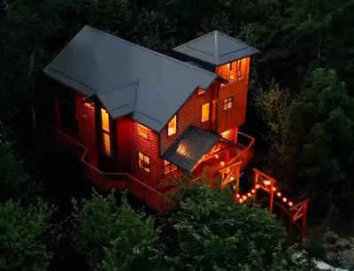 a tree house lit up at night with lights at Skyview Treehouse by Amish Country Lodging in Millersburg