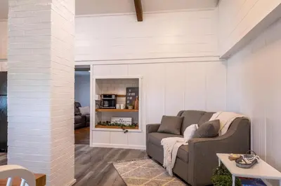 a living room with a couch and a table at Farmhouse of Blessings in Dundee