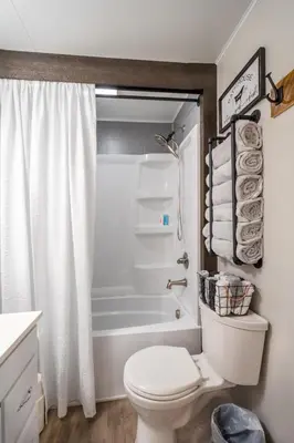 a bathroom with a toilet and a bath tub at Farmhouse of Blessings in Dundee