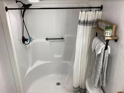 a bathroom with a tub and a shower curtain at Farmhouse of Blessings in Dundee