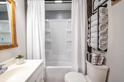 a bathroom with a white toilet and a shower at Farmhouse of Blessings in Dundee