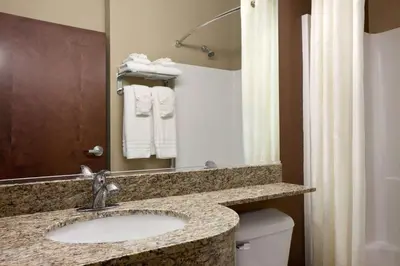 a bathroom with a sink and a toilet at Microtel Inn & Suites by Wyndham St Clairsville - Wheeling in Saint Clairsville