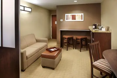 a living room with a couch and a table at Microtel Inn & Suites by Wyndham St Clairsville - Wheeling in Saint Clairsville
