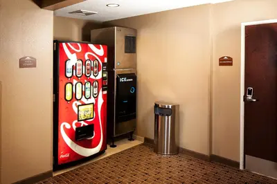 a coca cola vending machine in a hallway at Microtel Inn & Suites by Wyndham St Clairsville - Wheeling in Saint Clairsville