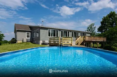 a swimming pool in front of a house at 80 Acres, Pool, Game room with Ping Pong & Billiards! in Williamstown