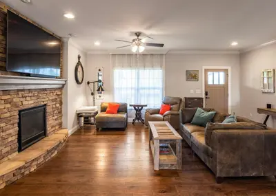 a living room with a couch and a fireplace at 80 Acres, Pool, Game room with Ping Pong & Billiards! in Williamstown