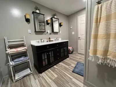 a bathroom with a sink and a mirror at Cottage near Cedar Point and downtown Sandusky in Sandusky