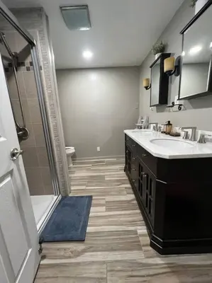 a bathroom with two sinks and a shower at Cottage near Cedar Point and downtown Sandusky in Sandusky