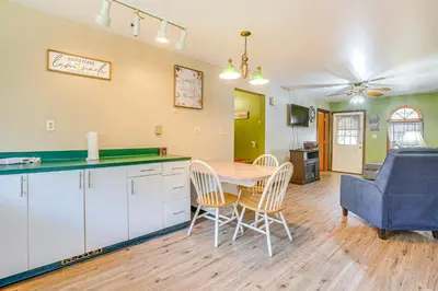 a kitchen and dining room with a table and chairs at Quaint Zanesville Home with Game Room and Yard! in Zanesville