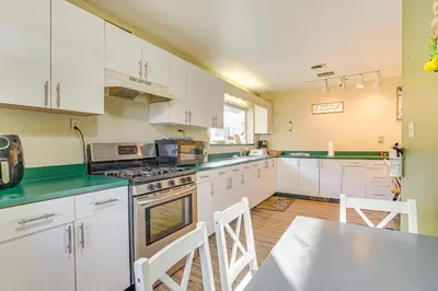 a kitchen with white cabinets and green counter tops at Quaint Zanesville Home with Game Room and Yard! in Zanesville