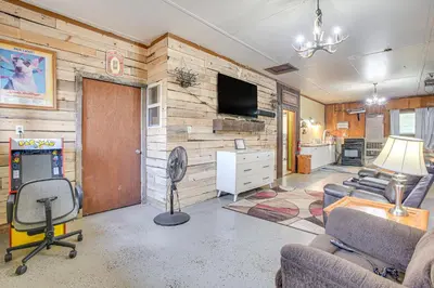 a living room with a room with a television and a living room at Quaint Zanesville Home with Game Room and Yard! in Zanesville