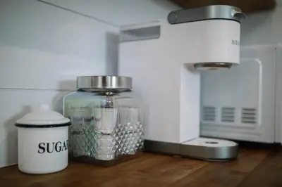 a kitchen counter with a mixer and a glass jar at Cozy Cottage on 250 Acre Dairy Farm Near Ark in Dry Ridge