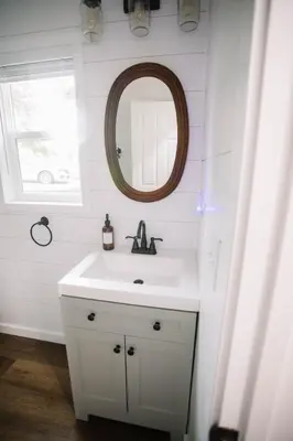 a bathroom with a white sink and a mirror at Cozy Cottage on 250 Acre Dairy Farm Near Ark in Dry Ridge