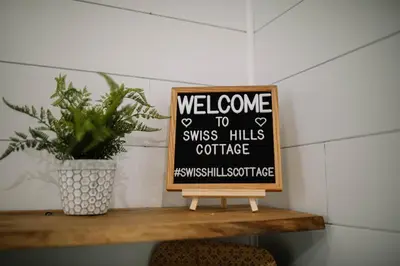 a sign that says welcome to swiss hills coffee at Cozy Cottage on 250 Acre Dairy Farm Near Ark in Dry Ridge