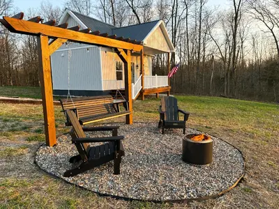 a gazebo with a bench and a fire pit at Cozy Cottage on 250 Acre Dairy Farm Near Ark in Dry Ridge