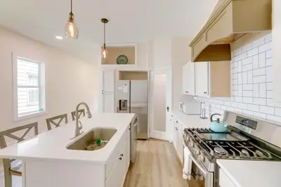a white kitchen with a sink and a stove at Historic Madison Retreat - 1 Mi to Ohio River in Madison