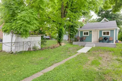 a small blue house with a table and chairs in a yard at Historic Madison Retreat - 1 Mi to Ohio River in Madison