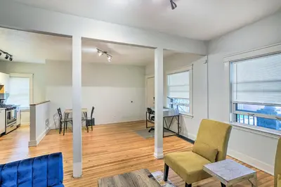 an empty living room with a table and chairs at 3 Mi to Dtwn Walkable Apt in Cleveland! in Cleveland