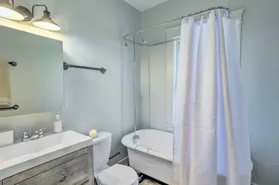 a white bathroom with a toilet and a shower at 3 Mi to Dtwn Walkable Apt in Cleveland! in Cleveland