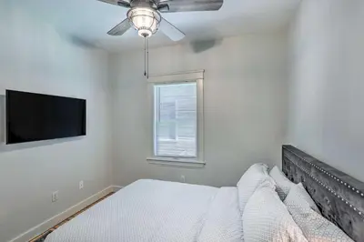 a bedroom with a bed and a flat screen tv at 3 Mi to Dtwn Walkable Apt in Cleveland! in Cleveland