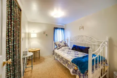 a bedroom with a white bed and a table at BBQ, Fire Pit and Yard Family Home in Adrian in Adrian