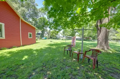 two chairs and a table under a tree at BBQ, Fire Pit and Yard Family Home in Adrian in Adrian