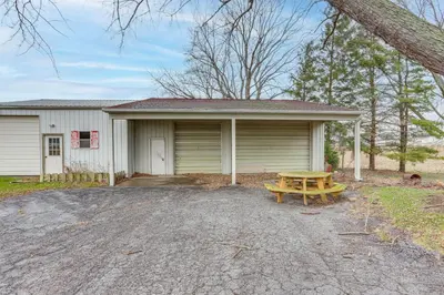 a house with a picnic table in front of it at Central and Private Milan Home about 10 Mi to Sandusky! in Milan