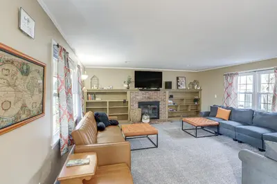 a living room with a blue couch and a fireplace at Central and Private Milan Home about 10 Mi to Sandusky! in Milan