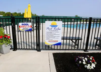 a black fence with a pool and a sign on it at Bayfront Resort at Cross View Site #28 in Sandusky