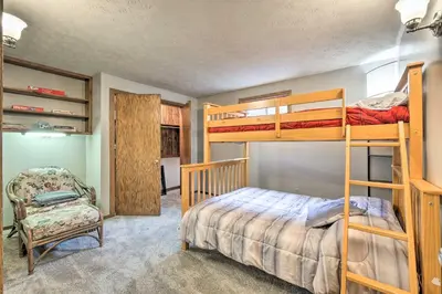 a bedroom with two bunk beds and a chair at Mimis Place about Ohio Countryside Duplex with Deck in Orrville