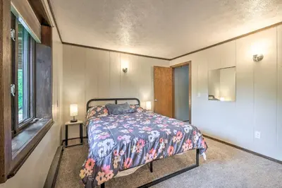 a bedroom with a bed in a room with a window at Mimis Place about Ohio Countryside Duplex with Deck in Orrville