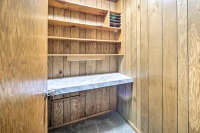 a wooden cabinet with a shelf in a room at Mimis Place about Ohio Countryside Duplex with Deck in Orrville