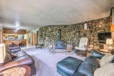 a living room with a stone wall at Mimis Place about Ohio Countryside Duplex with Deck in Orrville