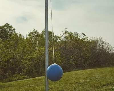 a blue ball hanging from a pole in a field at Luxury Cabin w/ Game Room & Hot Tub at Cave Run Lake in Wellington