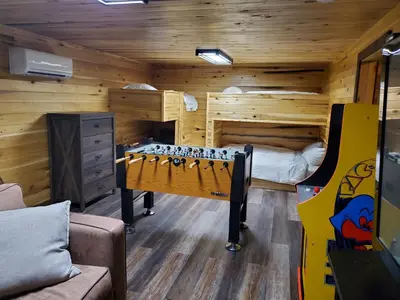 a room with a room with a bed and a chess board at Luxury Cabin w/ Game Room & Hot Tub at Cave Run Lake in Wellington