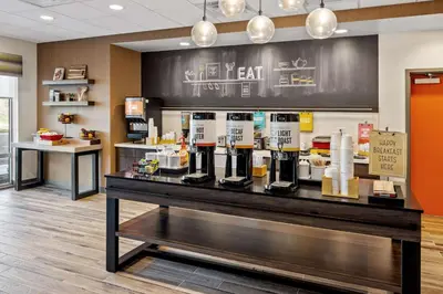 a coffee shop with a counter with a coffee machine at Hampton Inn & Suites Cincinnati West, Oh in Dent