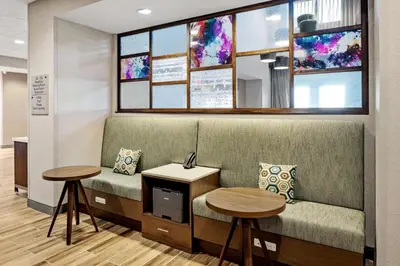 a waiting room with a couch and two tables at Hampton Inn & Suites Cincinnati West, Oh in Dent