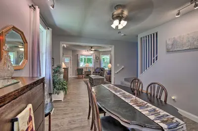 a dining room and living room with a table and chairs at Spacious Fort Wayne Condo with Porch and Storage! in Fort Wayne