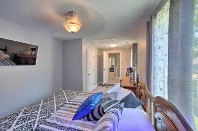 a bedroom with a bed with blue pillows on it at Spacious Fort Wayne Condo with Porch and Storage! in Fort Wayne