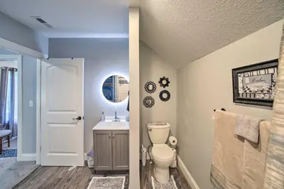 a bathroom with a toilet and a sink at Spacious Fort Wayne Condo with Porch and Storage! in Fort Wayne