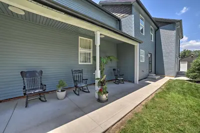 a house with two chairs and a porch at Spacious Fort Wayne Condo with Porch and Storage! in Fort Wayne
