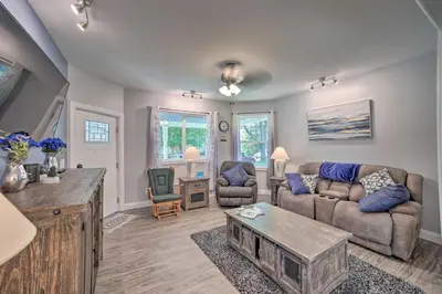 a living room with a couch and a table at Spacious Fort Wayne Condo with Porch and Storage! in Fort Wayne