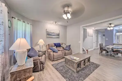a living room with a couch and a table at Spacious Fort Wayne Condo with Porch and Storage! in Fort Wayne