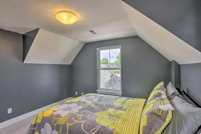 a bedroom with a bed and a window at Central Cleveland Gem with Direct Skyline View! in Cleveland