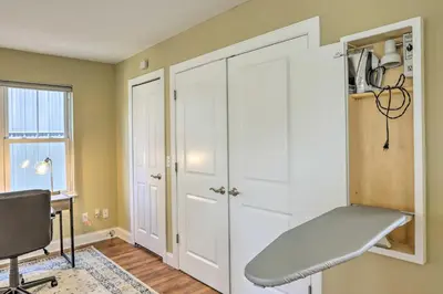 a white closet with a bench in a room at Central Cleveland Gem with Direct Skyline View! in Cleveland