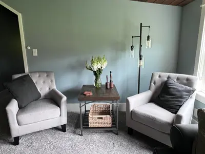 two chairs and a coffee table in a living room at Modern Industrial Farmhouse - The Wayback in Orange