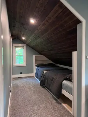 two beds in a room with a wooden ceiling at Modern Industrial Farmhouse - The Wayback in Orange