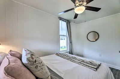 a bedroom with a bed with a ceiling fan at Pet-Friendly Greenville Home with Private Yard in Greenville