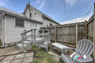 a patio with two chairs and a bench and a fence at Pet-Friendly Greenville Home with Private Yard in Greenville
